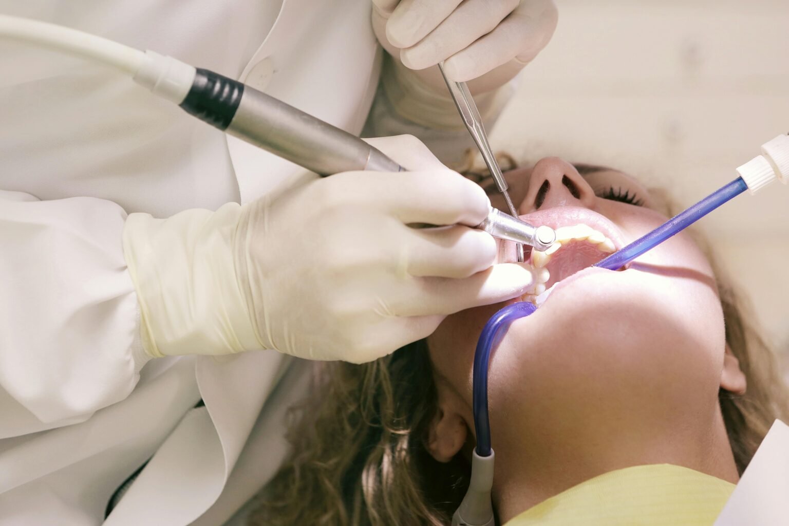 Acasa Close-up of a dental procedure with tools in a clinic setting, patient undergoing treatment.