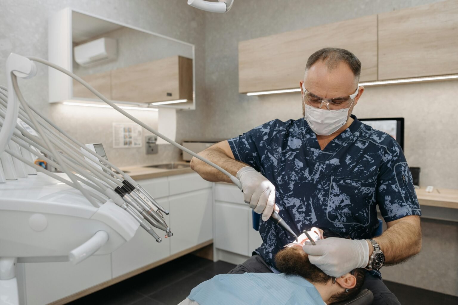 Acasa Dentist performing a routine dental examination on a patient in a modern clinic setting.